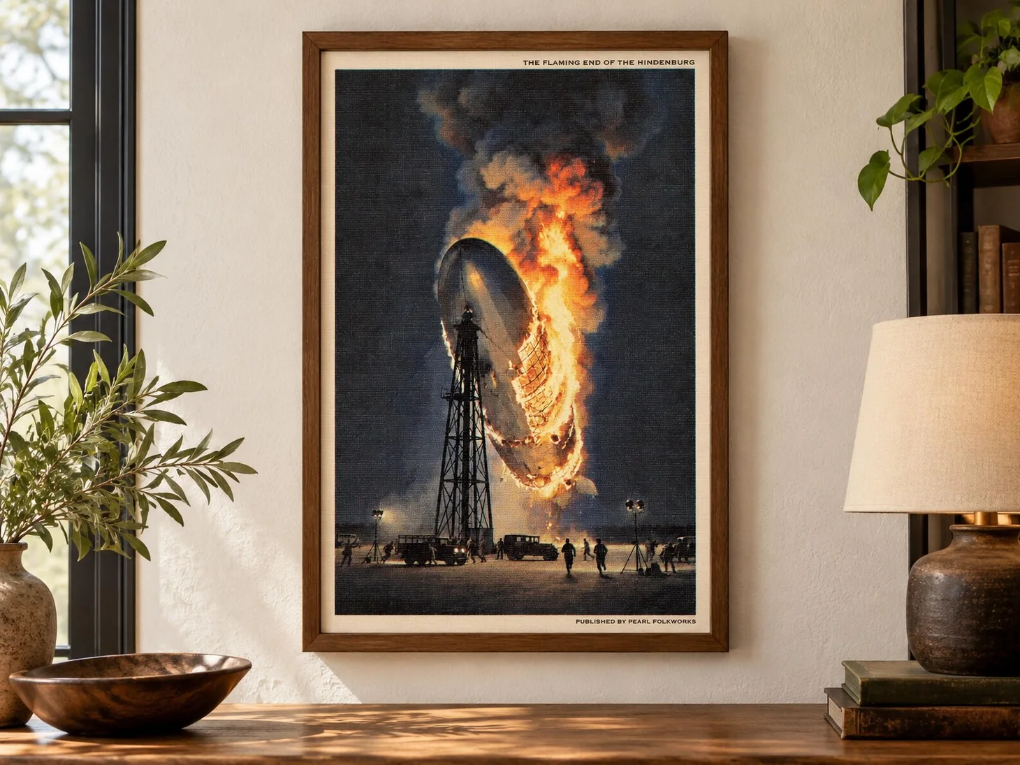 Framed illustration of the Hindenburg airship engulfed in flames over its mooring mast.