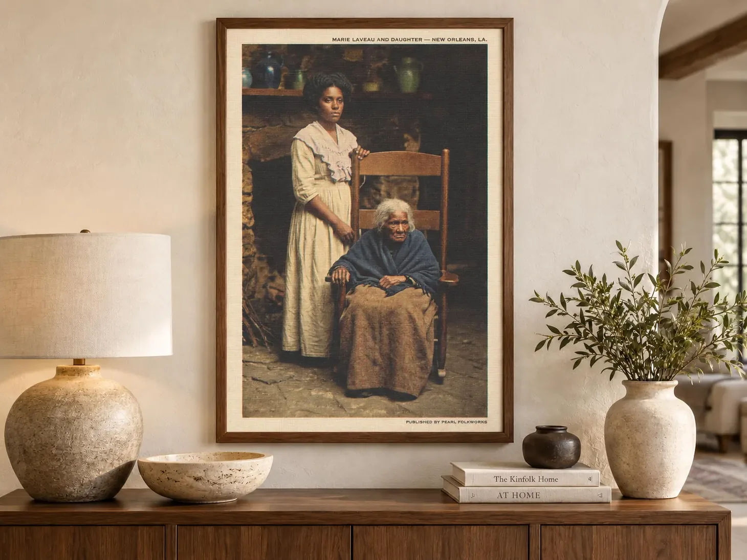 Framed historical-fiction-style art print depicting Marie Laveau and a younger woman in a rustic interior.